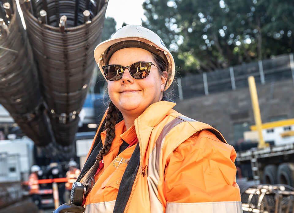 Photo of a woman in high-vis on a construction site